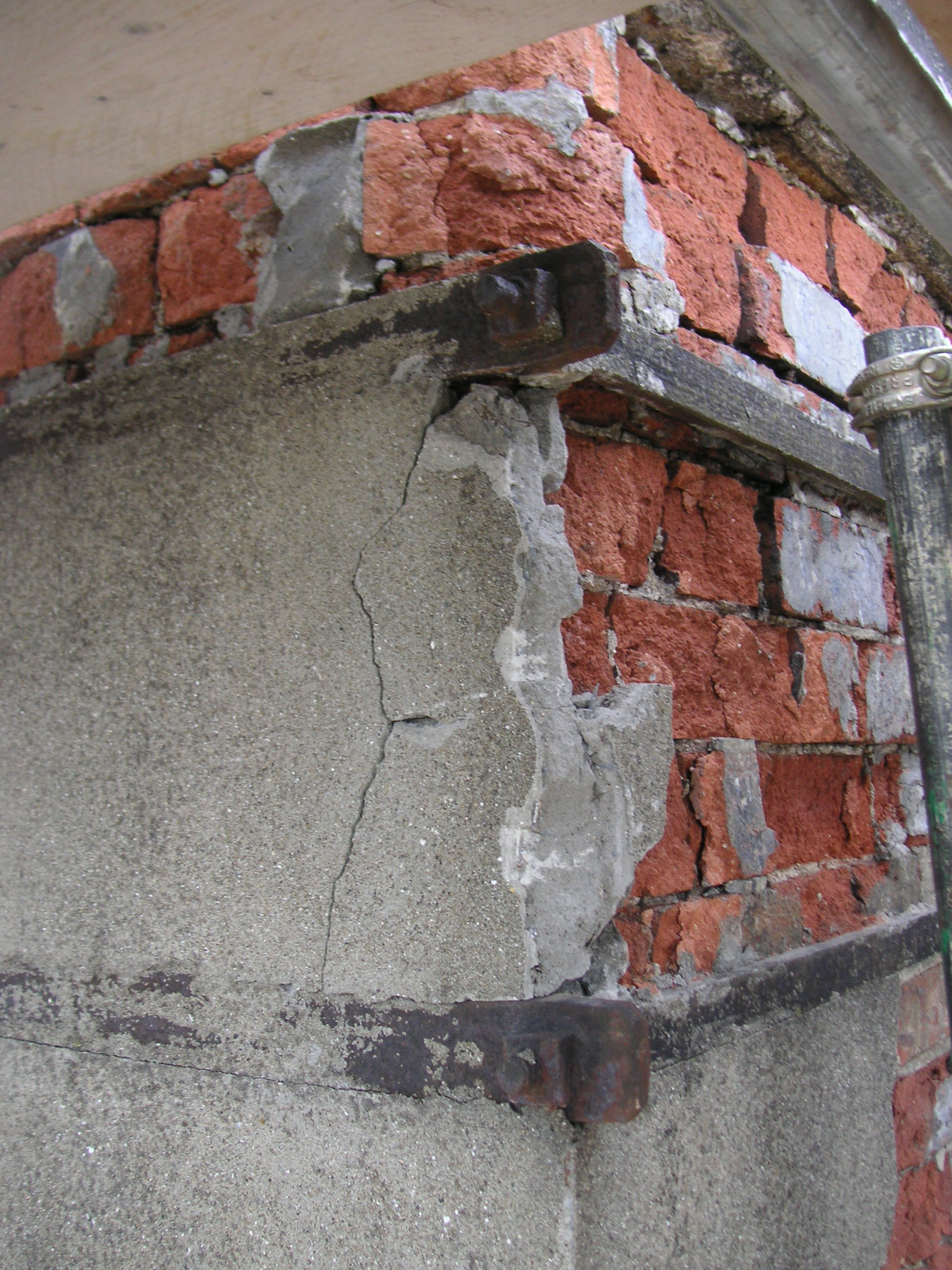 Brick damaged by cement render at Brandon House Hotel